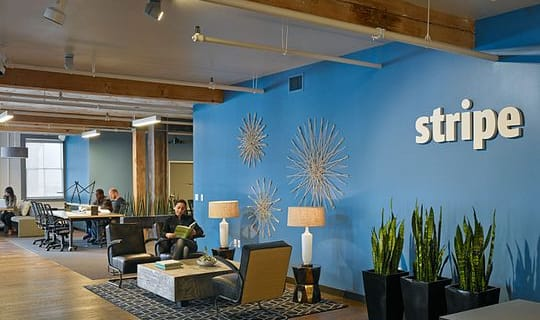 Stripe office lounge with logo wall